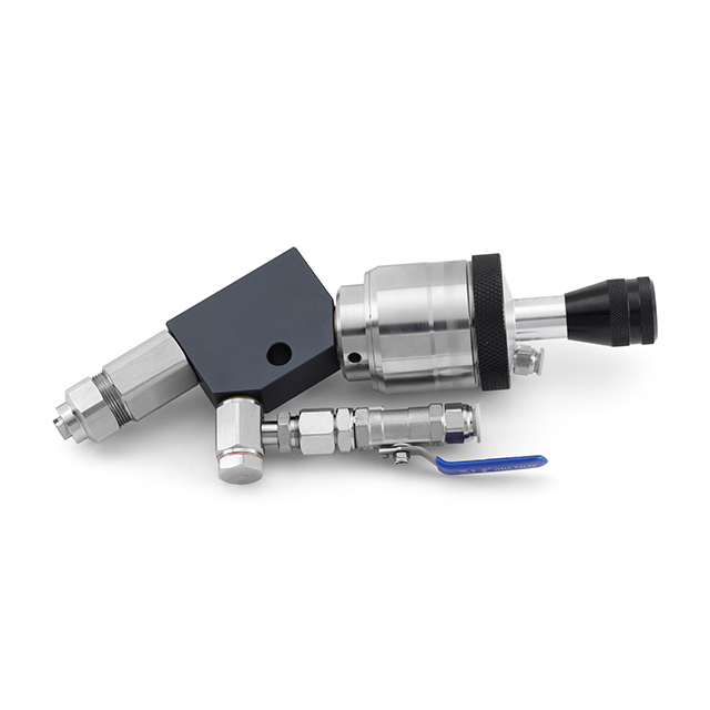High pressure liquid compound spray gun applying abrasive to a buffing wheel